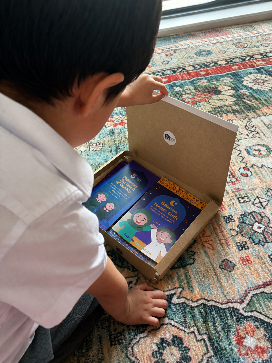 Child opening a box on a patterned rug